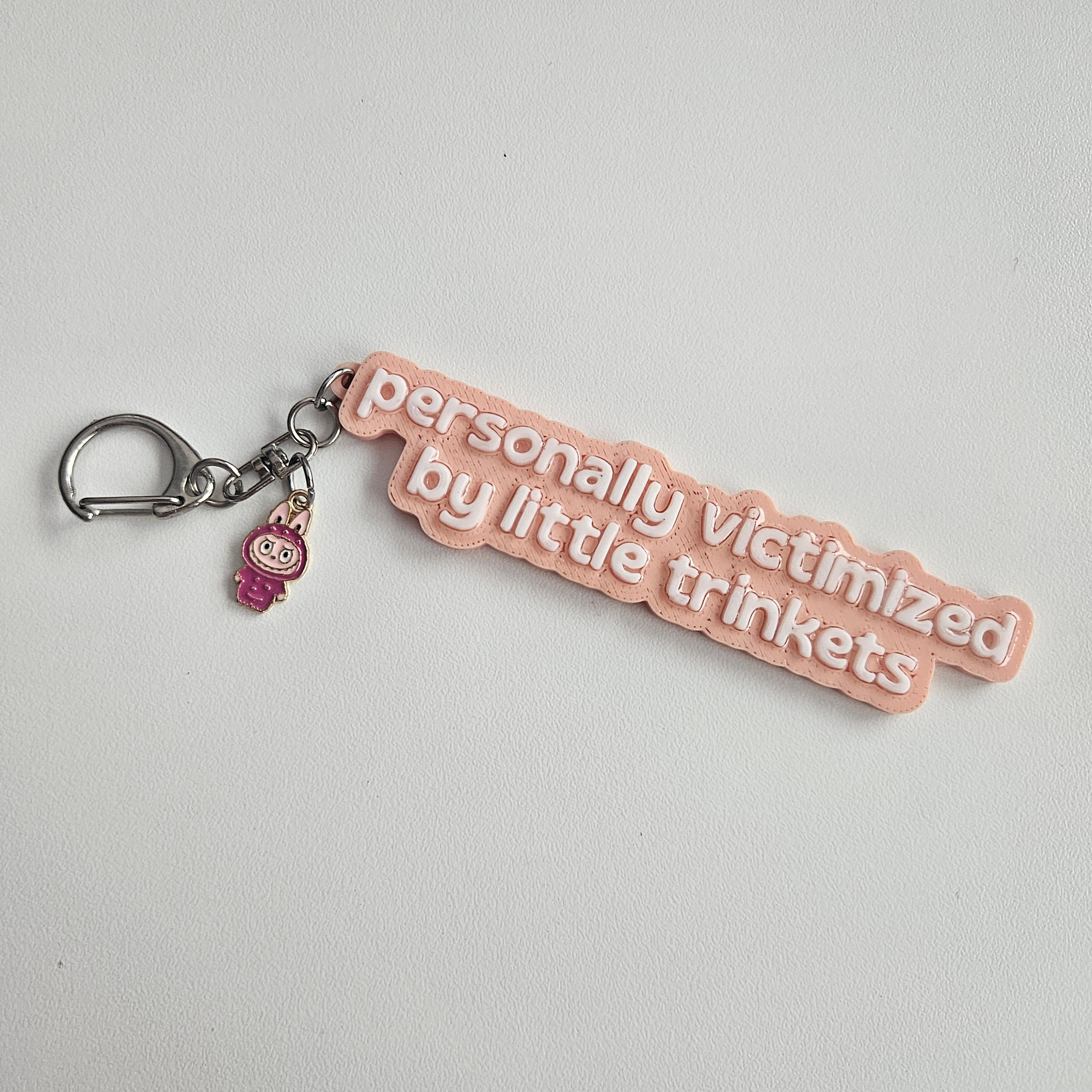 "personally victimized by little trinkets" Keychain